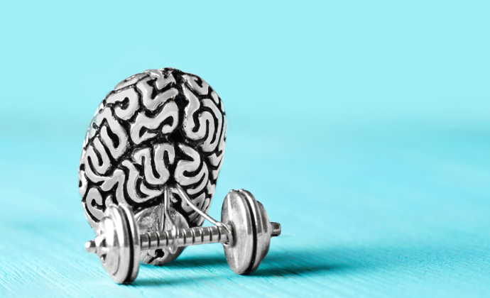 Metallic brain with hand weights on blue background for brain pacemaker Parkinson's article.
