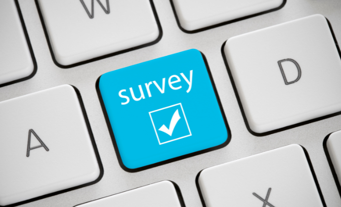 Blue survey icon on keyboard for the communications survey article.