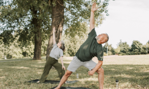 Couple doing yoga in the park