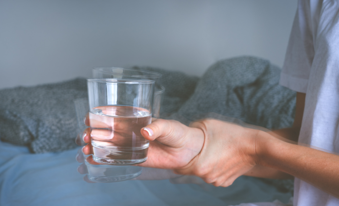 Glass of water shaking in hands