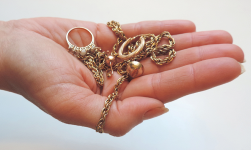 Hand holding gold jewellry