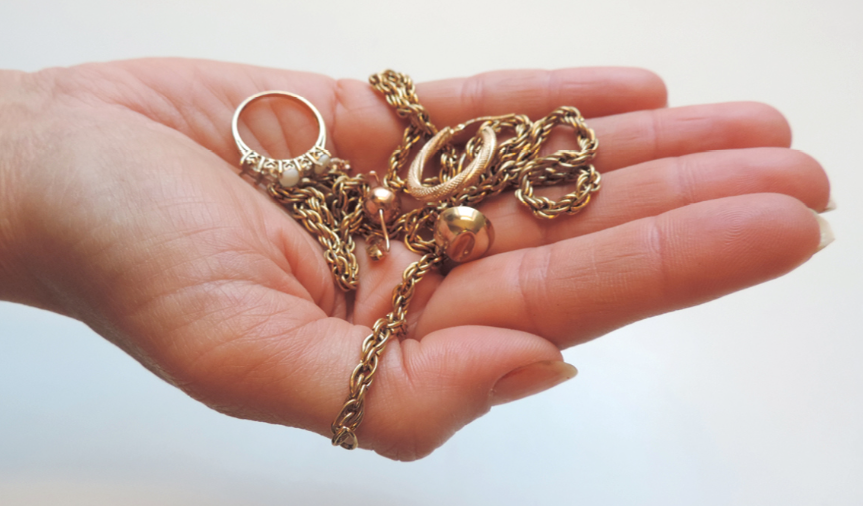 Hand holding gold jewellry