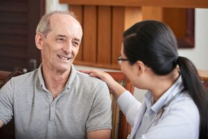 Older man with lady hand on shoulder