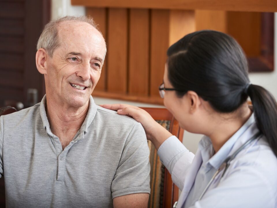 Older man with lady hand on shoulder