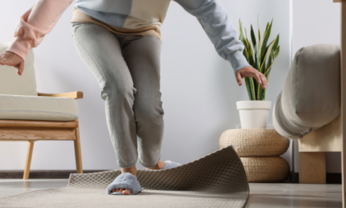 Older person tripping over mat